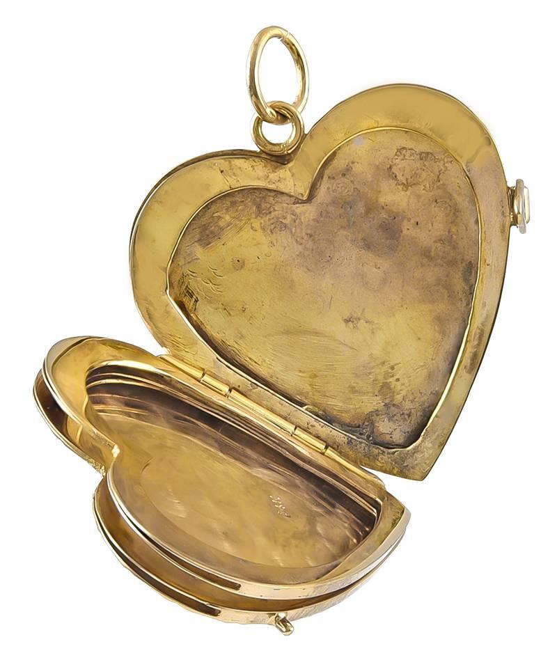 Beautiful heart locket.  14K yellow gold.  Front has a matte finish, with shiny gold floral and leaf engraving.  14K yellow gold.  Opens to reveal bezels for four pictures.  1 1/4" x 1 1/4."  A timeless and romantic piece of