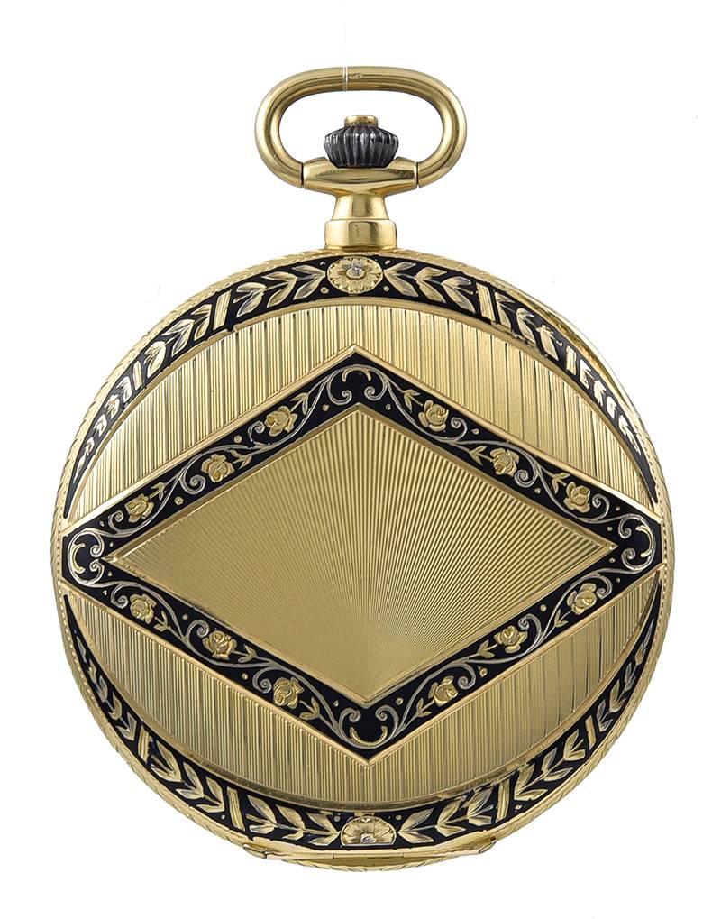 Outstanding tuxedo style pocket watch.  Made and signed by CARTIER; retailed by Carlos Perret.   18K yellow gold.  Black enamel fine-line enamel tracery around the borders.  On the front is a diamond-shaped cartouche with two beautifully enameled