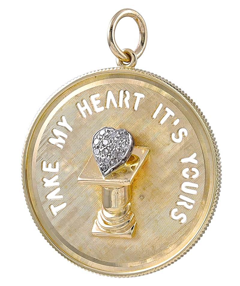 Large round charm with cut-out letters that say 