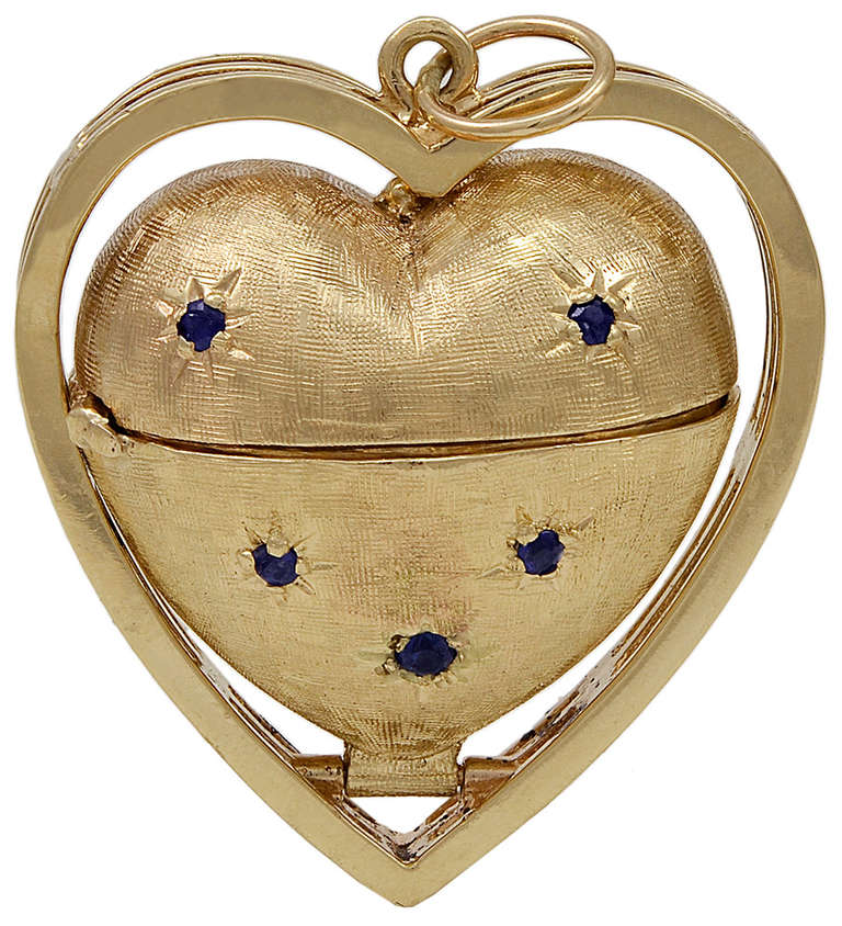 Large  14K heart shaped locket. Beautiful brushed gold finish with rubies on one side and sapphires on the other. It opens to reveal a place for six pictures.
Quite rare and wonderful. A perfect gift for Mother
