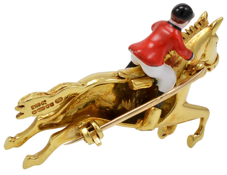 Be ready for a day at the races with this horse and jockey pin. The graceful running horse is set in 18K gold, with mane and tail flying. The jockey is dressed in crimson, black and white enamel colors. A vibrant elegant piece of jewelry.