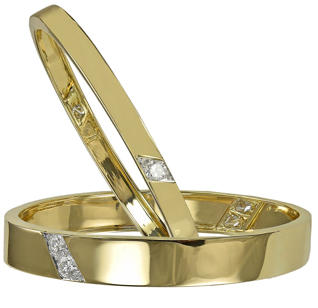 Two 18K yellow gold bangle bracelets.  Made, signed and numbered by Cartier.  Set with brilliant faceted diamonds (3.50 cts) set in a diagonal pattern on front and back of each bracelet.  These bracelets complement each other and are meant to be