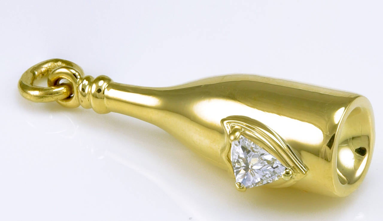 Figural champagne bottle in 14K yellow gold. Set with .40ct diamond.  
1 1/4