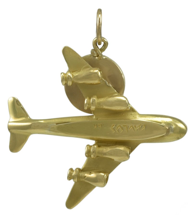 Great figural charm. A large 18K yellow gold airplane, with a (non-working)
clock. 11/3 x 1 1/3