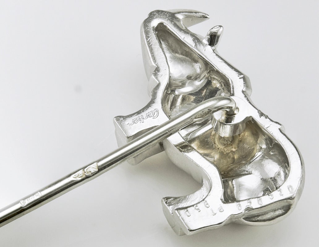 Fabulous figural rhinoceros stick pin.  Made, signed and numbered by Cartier  .  Set in very heavy platinum.  1