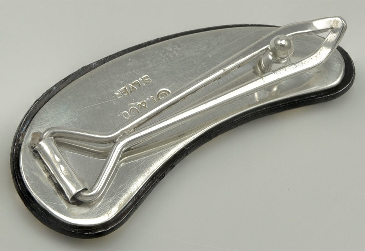Silver and steel barrette, with gold plated decoration. Made by Tiffany & Co. 

Organic shape.  1 1/2
