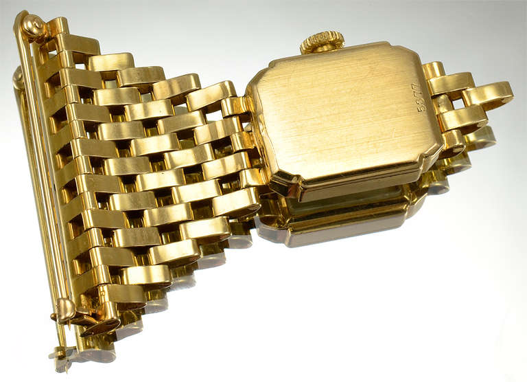 Cartier lady's 14k yellow gold lapel watch, suspended from woven mesh pin. Watch is mechanical and in fine working condition. Attractive, distinctive piece of Cartier jewelry.