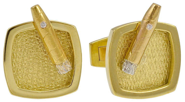 Unique cigar and ashtray cufflinks. 18K gold textured yellow gold cigar and ashtray; shimmering white gold ash at end of cigar and diamond in cigar. Clever design that is well executed. Solid. Great to wear or give as a gift,