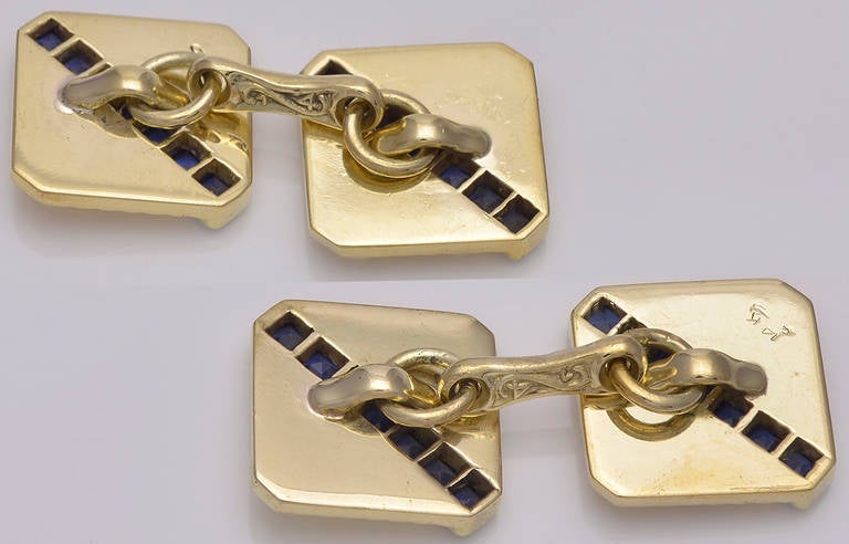 Sapphire and gold double-sided cufflinks, early  art deco period, circa 1935.
Square shape with cut corners;set in 14k gold; fine line decoration; intersected by a diagonal line of calibre-cut sapphires.
 A handsome classic cufflink.
Perfect for