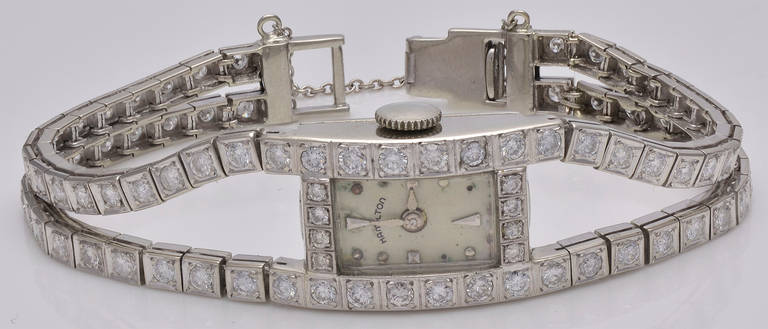Hamilton lady's 14k white gold and diamond Art Deco slinky and feminine double line bracelet watch. Set with approximately 4cts of sparkling diamonds, circa 1925. The watch had a mechanical movement but it has been replaced by a quartz movement.