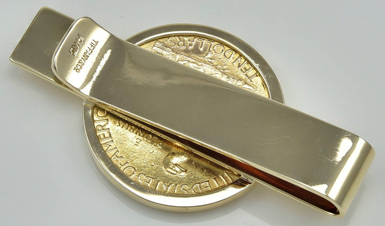 Most handsome money clip, set with a 1911 Ten Dollar gold coin.  Made and signed by TIFFANY & CO.  14K yellow gold clip.  2