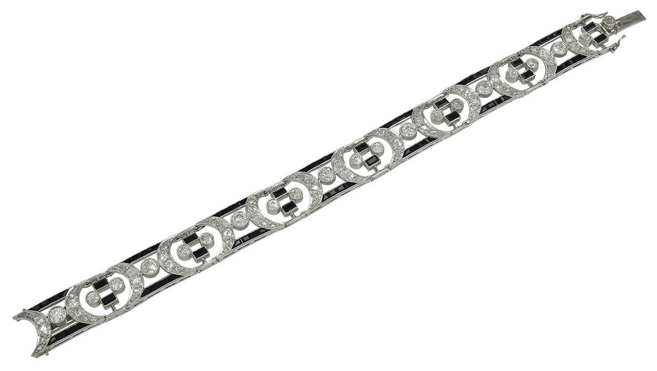 Most beautiful French Art Deco period bracelet. Approximately 10.0 cts of round brilliant cut diamonds, with a counterpoint of trapezoid and emerald-cut onyx. 7