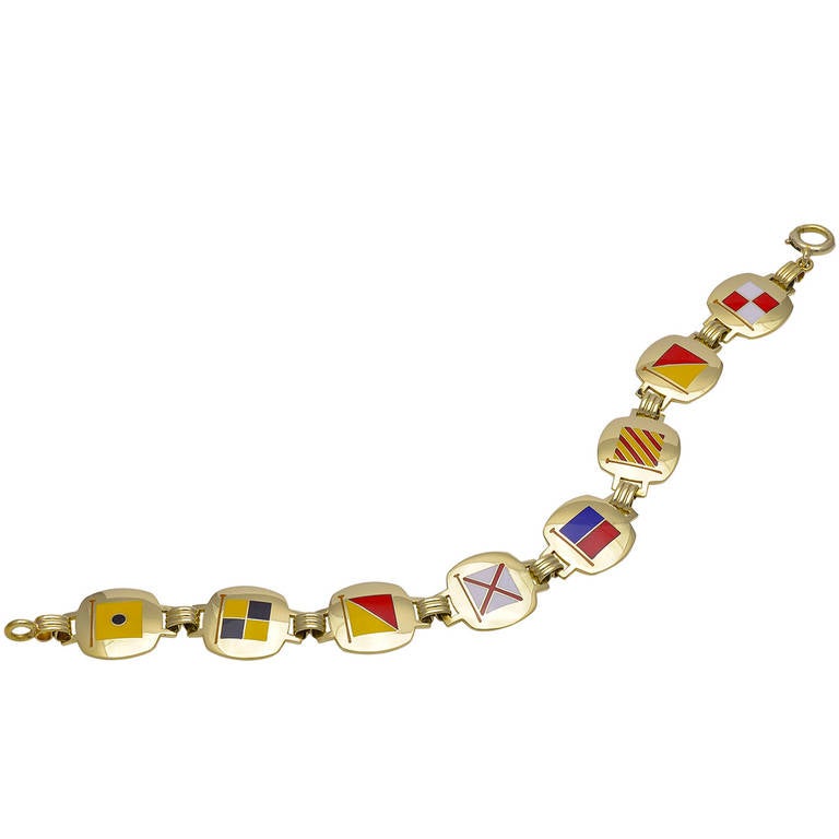 Great 14k yellow gold bracelet with nautical enamel flags that spell out 
