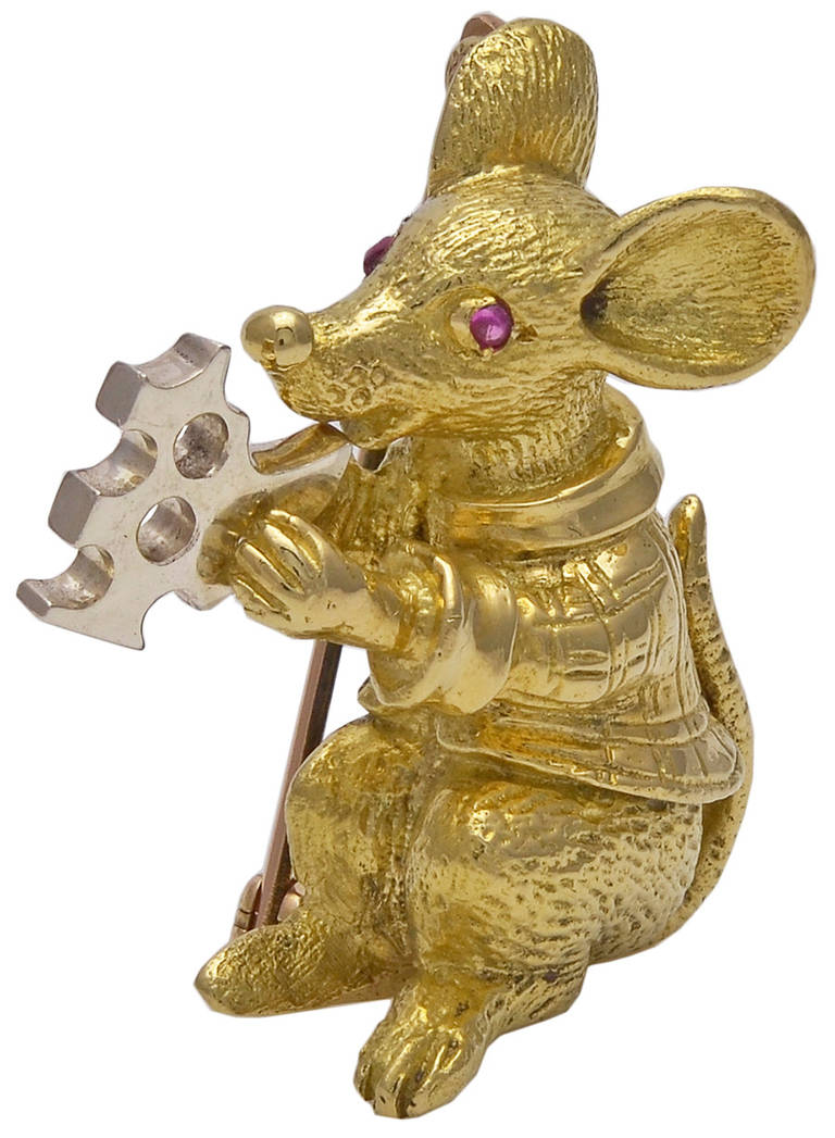 Figural mouse broach, 18K yellow gold with cabochon ruby eyes. Adorable seated mouse is holding a piece of swiss cheese. 
Very charming.