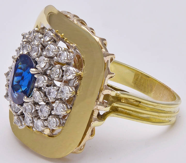Dramatic large cocktail ring. Center faceted 2.0cts sapphire, surrounded by 
1.35 cts of sparkling white diamonds in a sleek 14k gold setting.
A strong and bold look. Size 7 3/4 and may be easily sized.