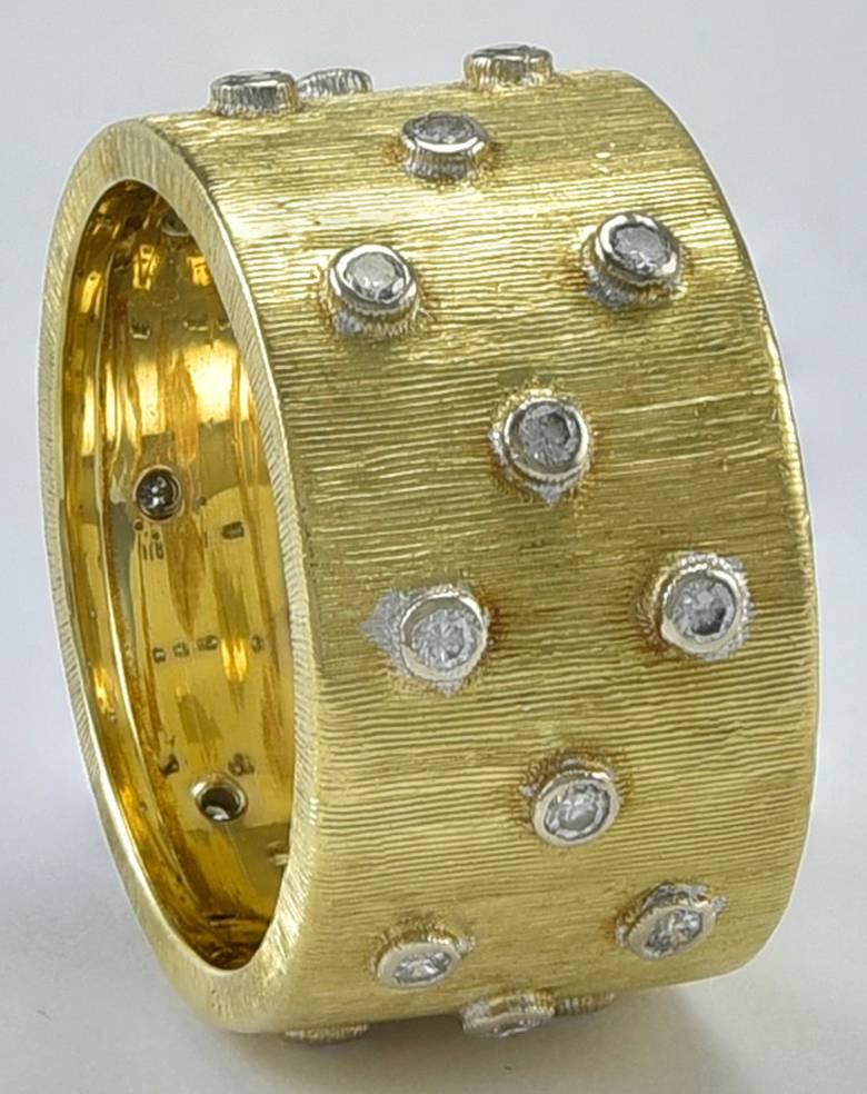 Shimmering 18K yellow gold band. Made and signed by Mario Buccellati. Set with 24 bright bezel set diamonds. Classic luminous Buccellati brushed gold finish. Size 51/2.  A classic ring.

Alice Kwartler has sold the finest antique gold & diamond