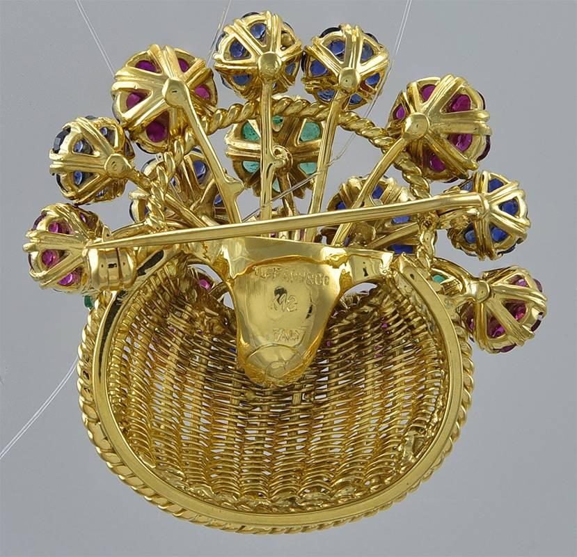 Gorgeous 18K yellow gold pin. Made & signed by Tiffany & Co. Figural flower basket, with en tremblant flowers set with rubies, emeralds & sapphires, centered with diamonds. This piece is alive with movement - a shimmering addition to your
