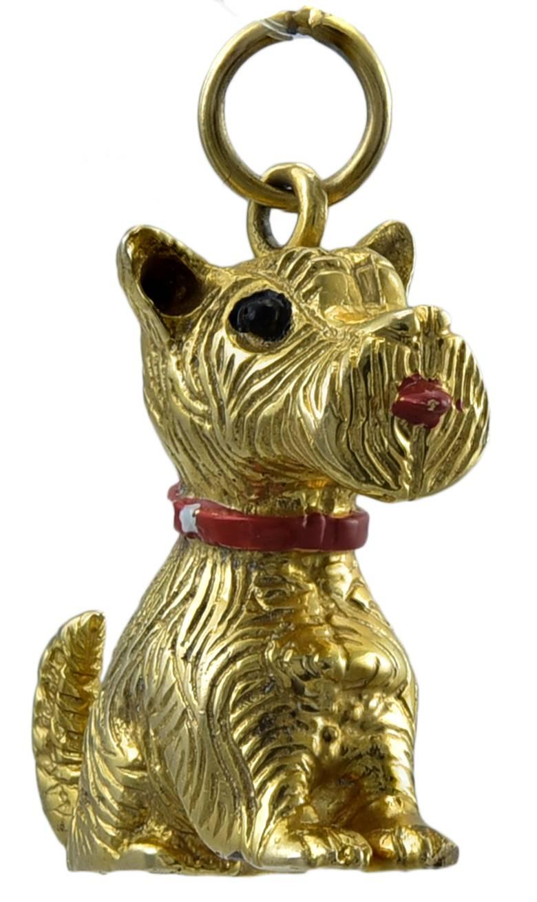 Adorable charm. A Westie, sitting down, with tail up, sticking his tongue out. 14K textured gold with a red & white enameled collar, black eyes and red tongue. 1