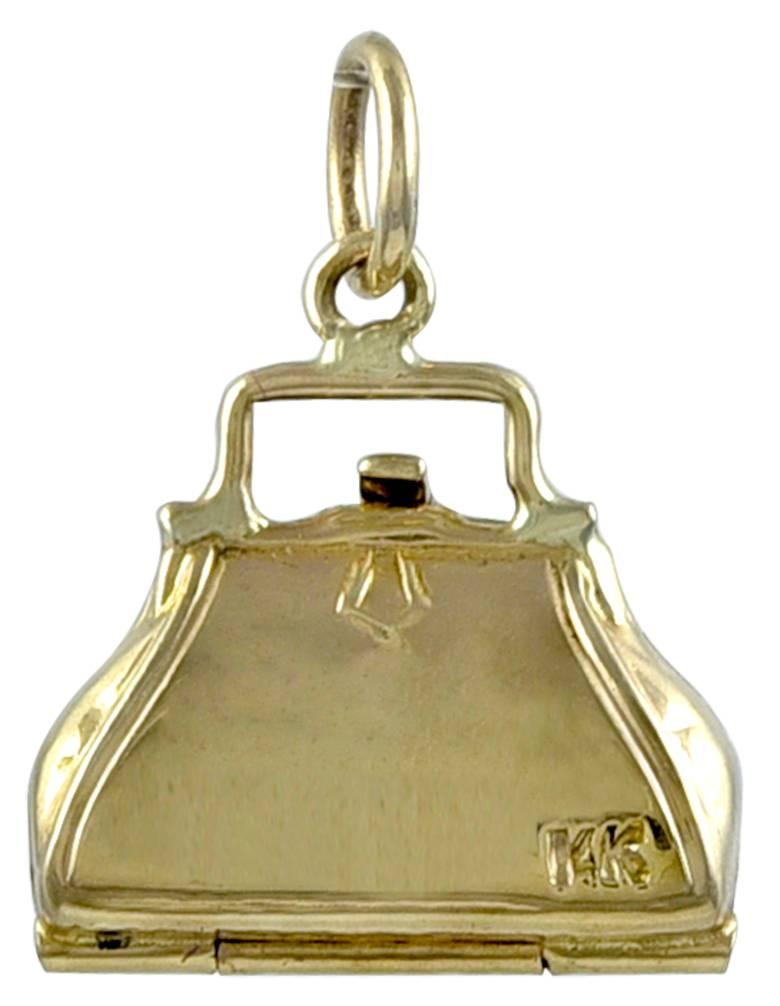 A figural 14K yellow gold pocketbook charm. Engraved 