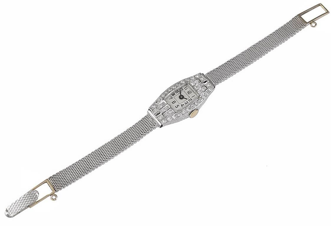 Beautiful diamond encrusted lady's wristwatch.  The watch is set in platinum, with approximately 1.20 cts. of brilliant cut diamonds.  On a 14K white gold solid mesh band.  For a dainty wrist, 6 1/3.