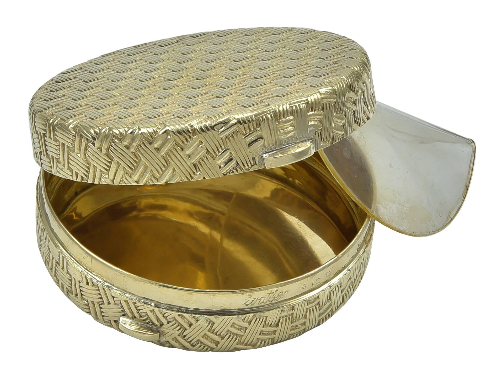 Well made basket weave pattern hinged pill box. Made, signed & numbered by Cartier. 14K yellow gold. 1-1/2