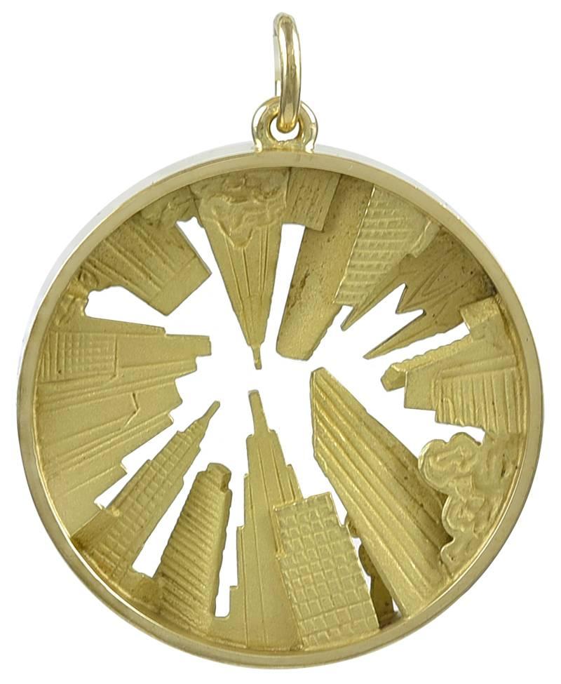 Beautiful and creative large New York skyline charm. Heavy gauge 18K gold. Made & signed by Gubelin. A solid outer rim encases a fanciful skyline,  showing the Torch from the Statue of Liberty, Radio City Music Hall, the United Nations, St.