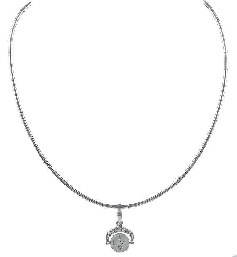 Unusual white gold charm necklace. Made, signed and numbered by CARTIER.  18K white gold.  Set with a spinner 