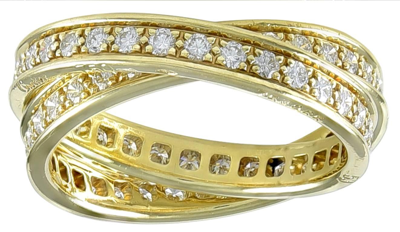 Rare example of the trinity collection with two interlocking rings.
Made, signed & numbered by Cartier. 18k yellow gold, fully set with round brilliant diamonds, approximately 1.50 carats total weight . Size 7.  No longer made by Cartier.

Alice