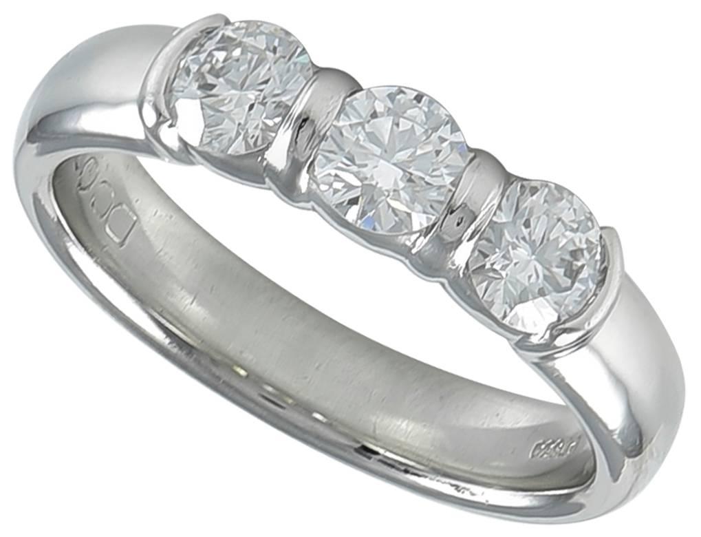 Brilliant three stone ring. Made & signed by Tiffany & Co. Three round brilliant diamonds, set in platinum, weighing 0.26, 0.27 and 0.26 carats respectively.   G color and VS1 clarity. Comes with three original numbered Tiffany Diamond Certificates.