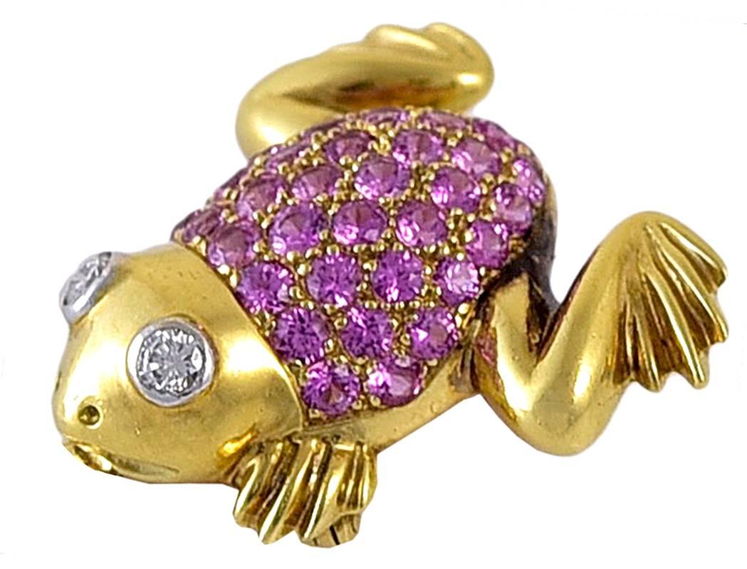 Most appealing figural frog pin.  18K yellow gold.  The body is completely encrusted with faceted pink sapphires.   The eyes are diamonds, set in platinum.
1