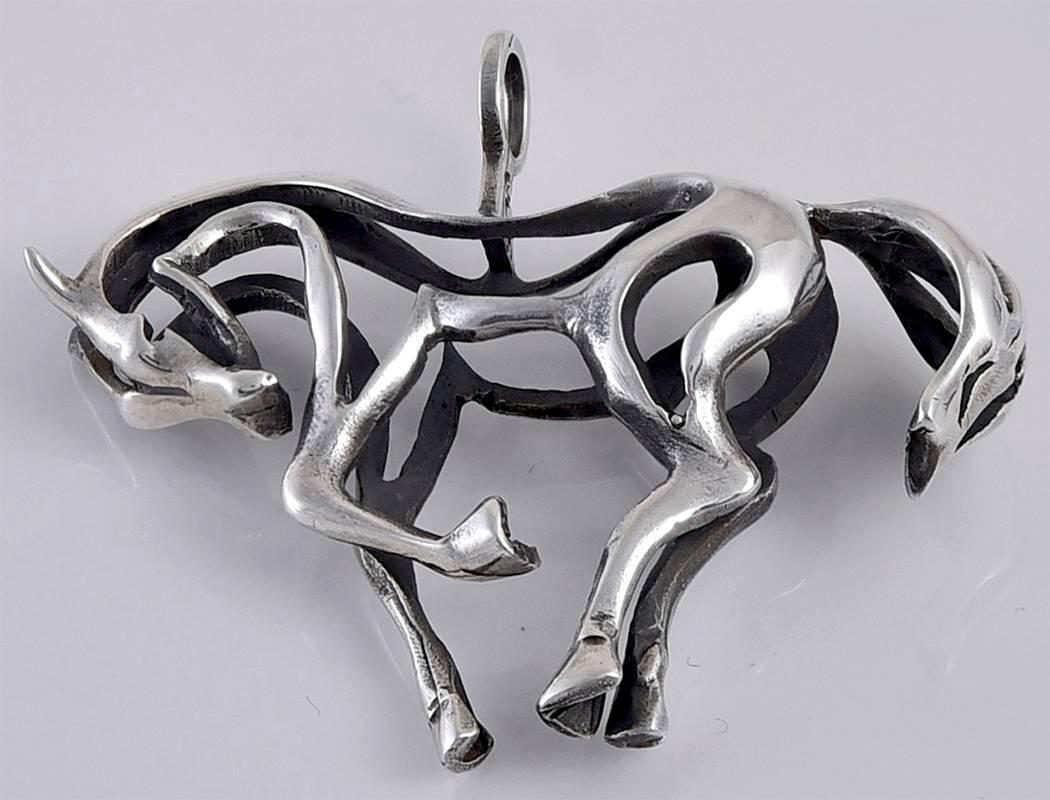 Sterling silver figural horse pin. Made and signed by Jorgen Jensen. An open work silhouette of a prancing horse. 1-2/3