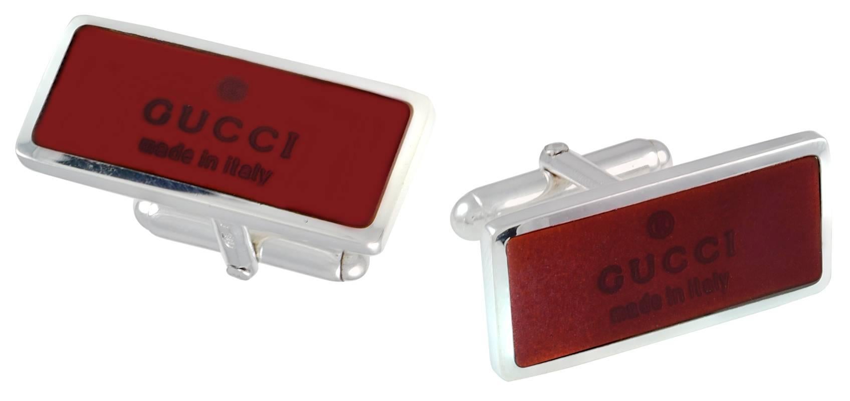 Handsome rectangular cufflinks.  Sterling silver with rich red enameling.  Inscribed in the enamel: 