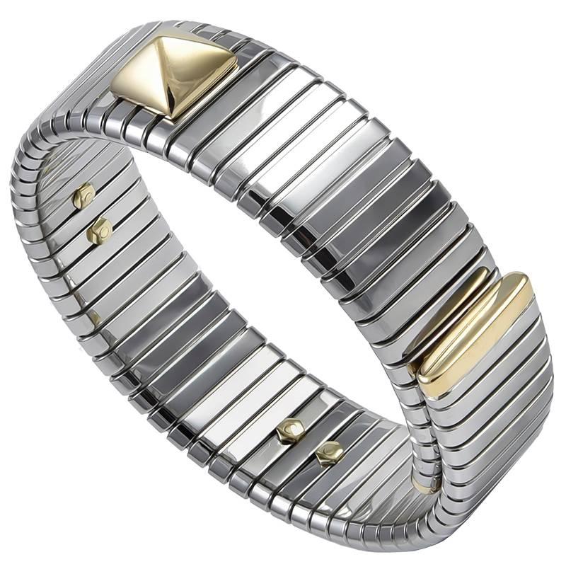 Flexible stainless steel wrap bracelet, with three 18K yellow gold applied pyramids and gold end links.  Made, signed and numbered by BULGARI.  Chic and edgy.

Alice Kwartler has sold the finest antique gold and diamond jewelry and silver for over