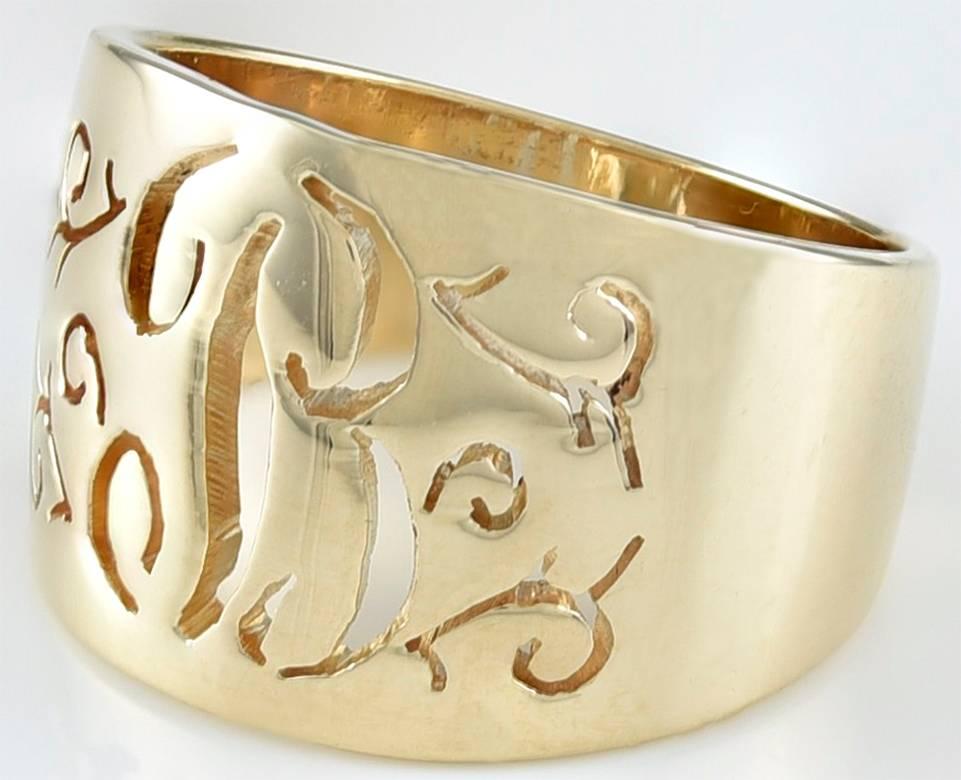 Graceful wide band ring, with pierced work around the center initial 