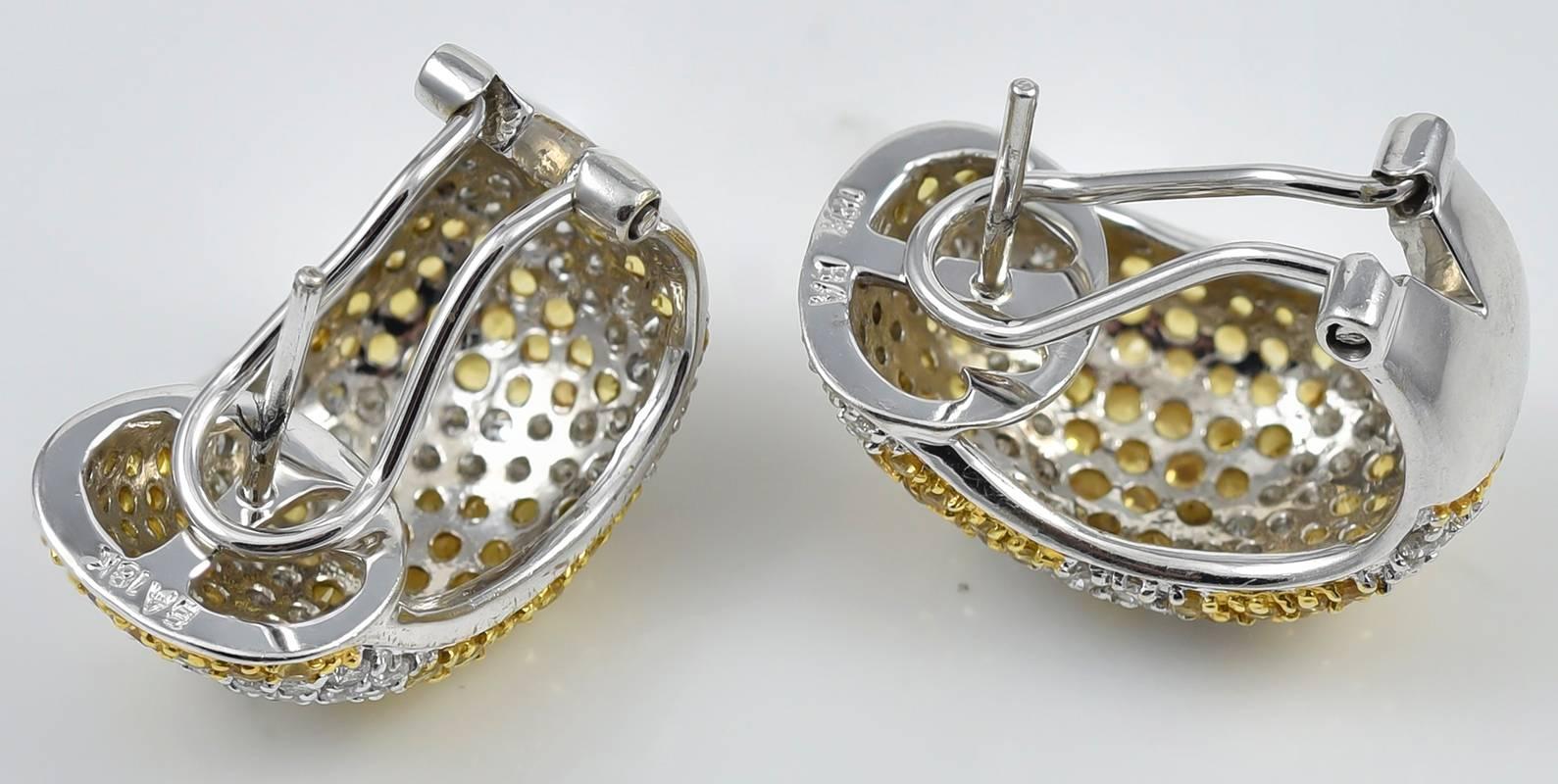 Very unusual and attractive earrings.  Yellow sapphires (2.0 cts.) and bright white diamonds (2.70 cts.) set in a diagonal line pattern.  18K white gold.  1/2