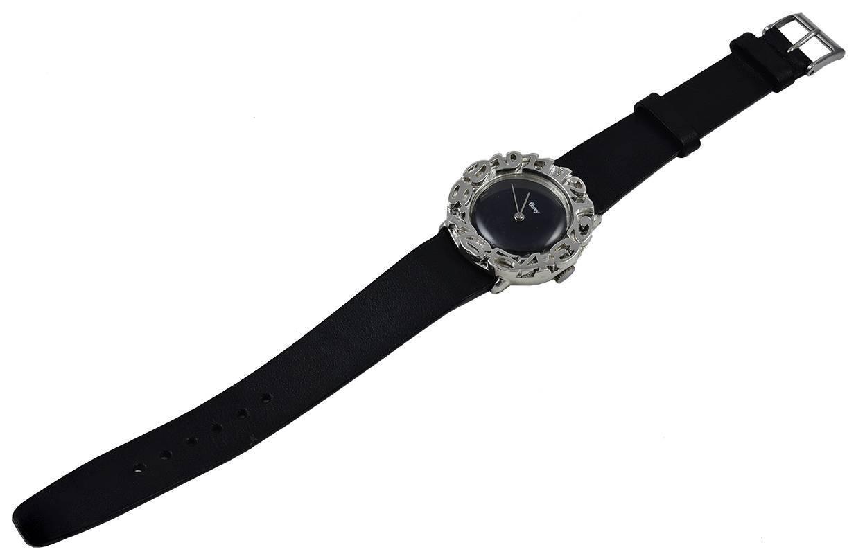 Striking ladies' wristwatch.  Made by OBREY Paris.  Round face, black dial.  Heavy beautiful applied numerals around the bezel.  1 1/3
