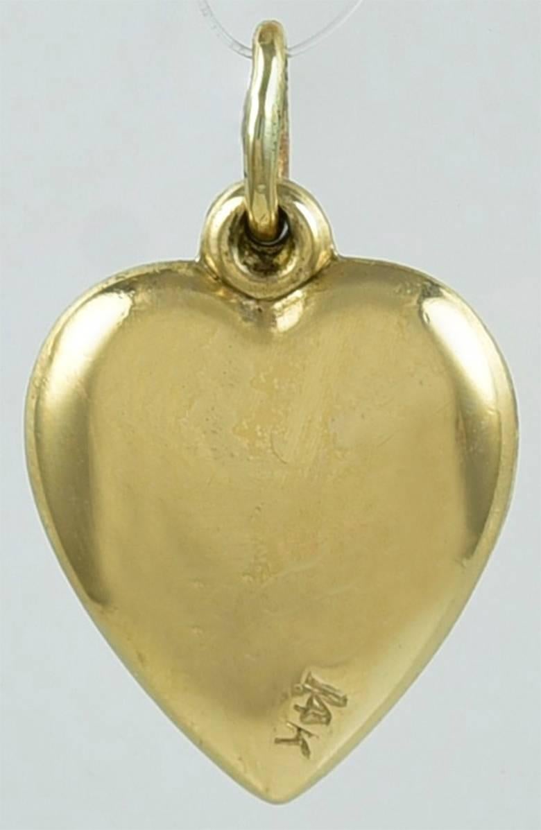 Charming charm.  A figural heart spinner, engraved 