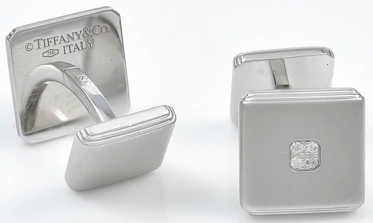 Elegant cufflinks.  Made and signed by TIFFANY & CO.   18K matte white gold, set with four center diamonds.  1/2