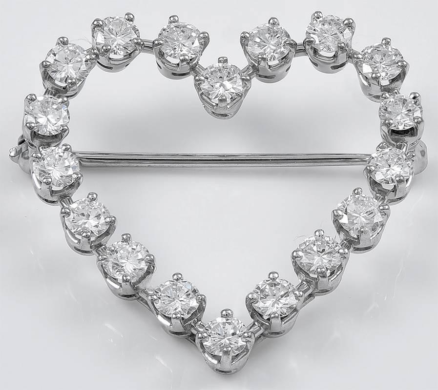 Beautiful sparkling figural heart brooch.  Made and signed by TIFFANY & CO.  Set in platinum.  Almost two carats of brilliant prong set diamonds, G-H color, VS clarity.  1 1/4