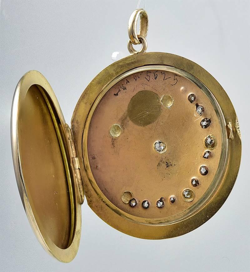Large antique hinged locket.  14K mellow rose gold, set with faceted diamonds. 
1 1/2
