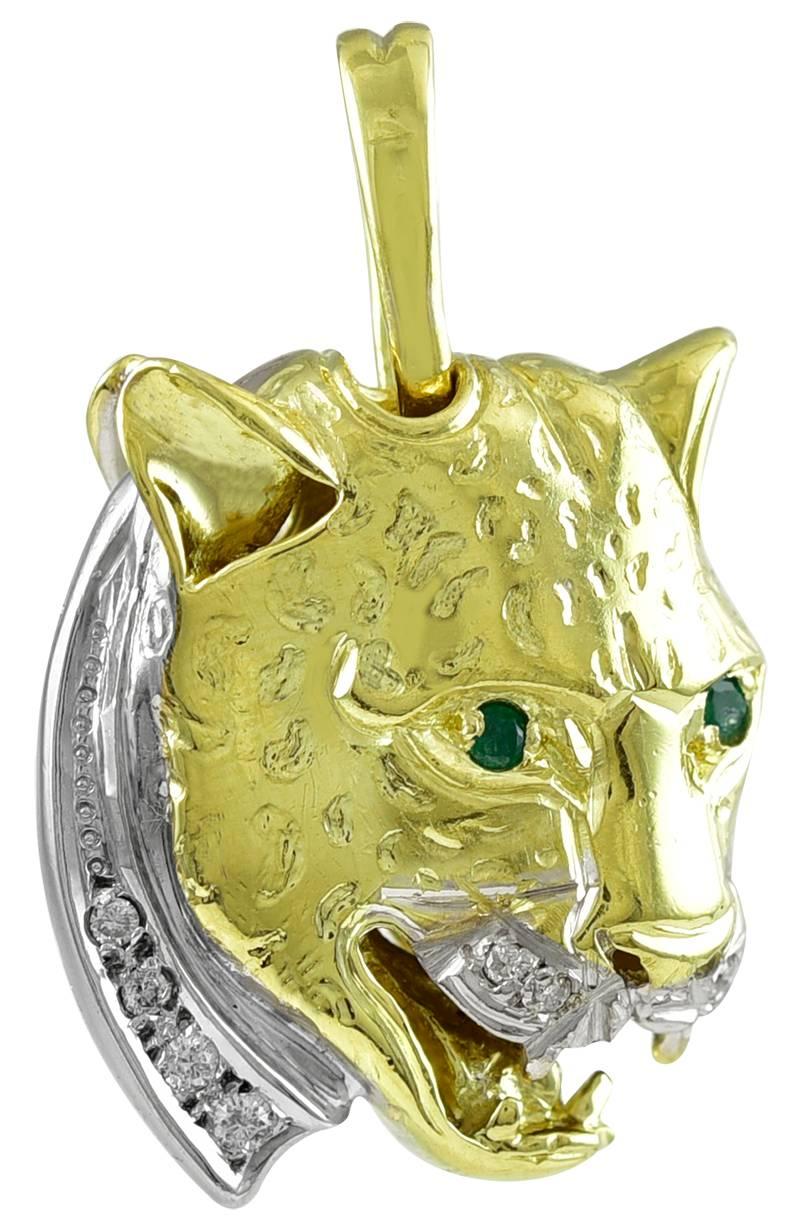 Fierce and fabulous figural leopard head pendant/charm.  One side is shiny gold, set with ruby eyes and diamonds; the other side is set with emerald eyes and diamonds, with textured gold spots.  Three dimensional.  3/4