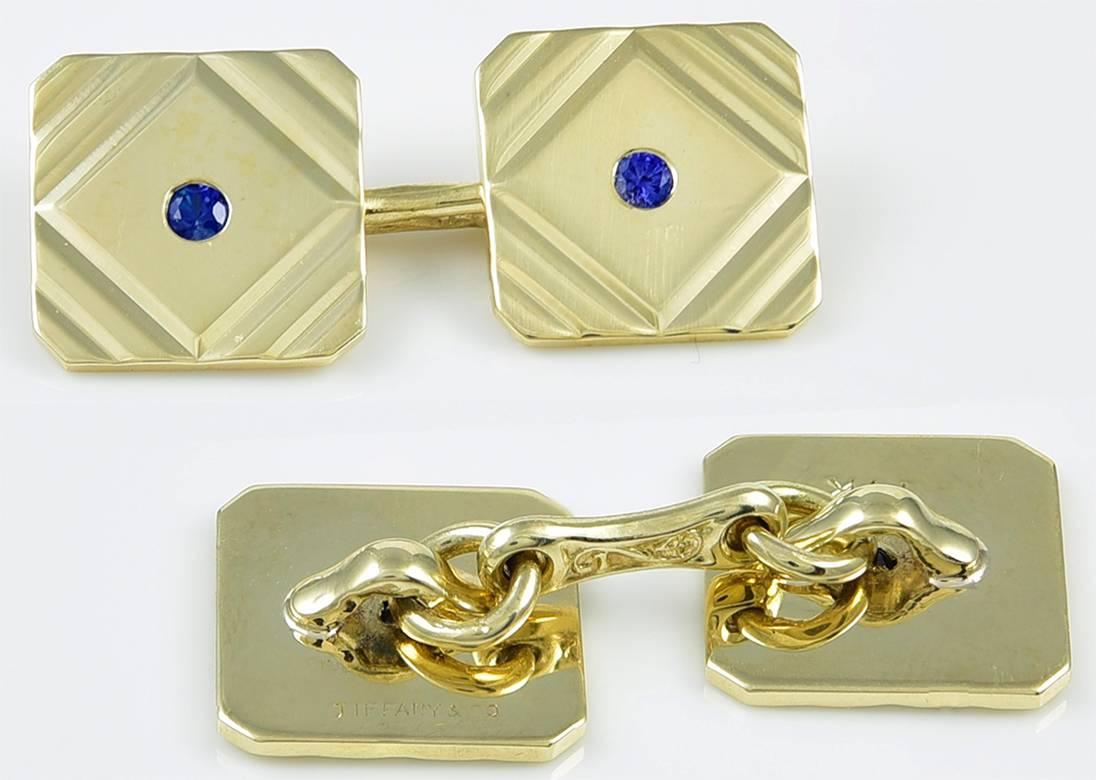 Classic Art Deco double-sided cufflinks.  Made and signed by TIFFANY & CO.  
14K yellow gold, with diagonal line cut corners and center faceted sapphires.  
1/2