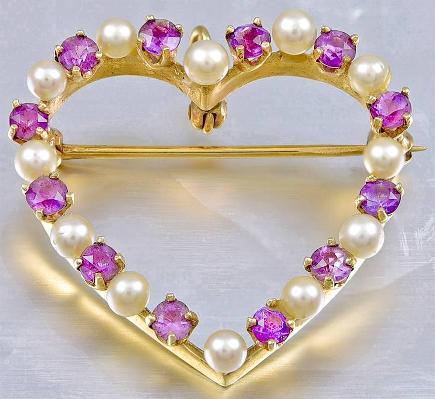 Lovely figural "heart" pin/pendant.  Set with alternating pearls and faceted amethysts.  14K yellow gold.  1 1/4" x 1."   A soft feminine look.

Alice Kwartler has sold the finest antique gold and diamond jewelry and silver for