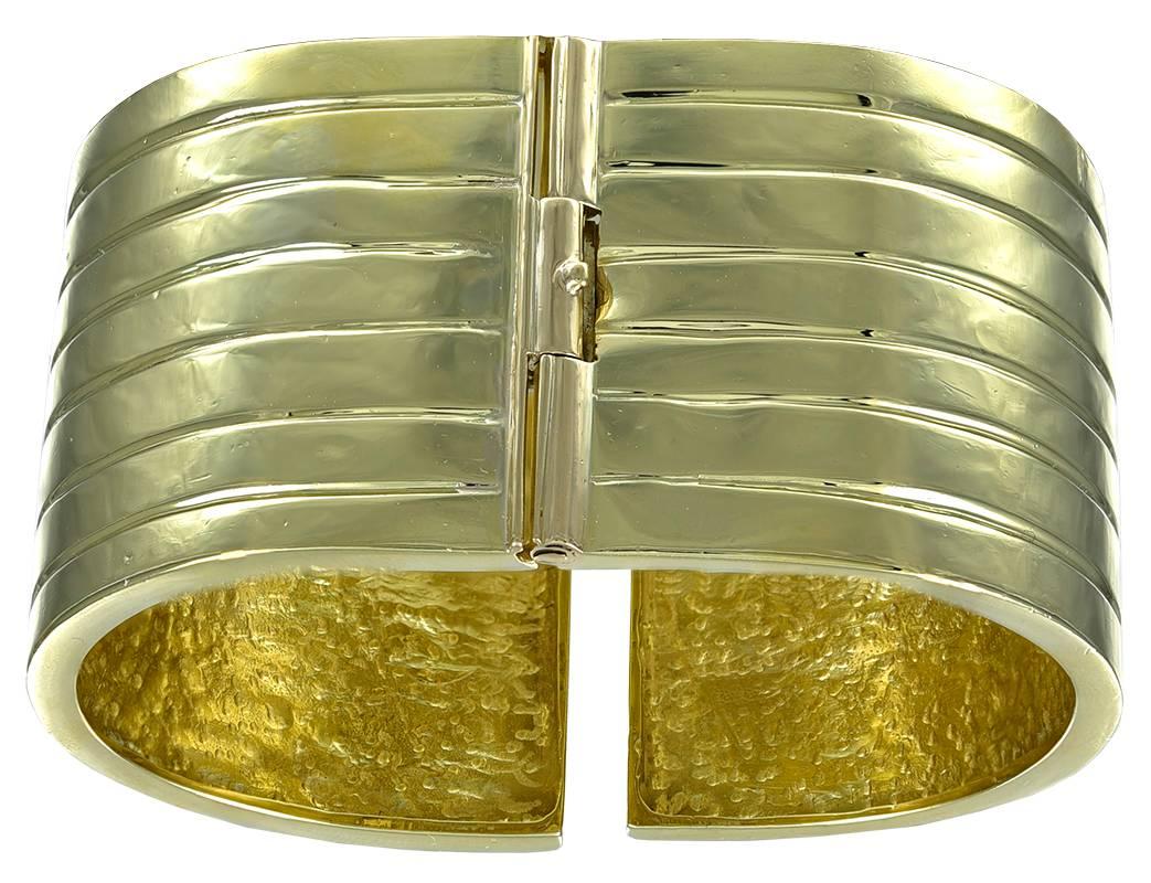 Superb hinged cuff bracelet.  Heavy gauge 18K yellow gold (114 grams).  Allover deep line engraved linear pattern.  1 1/4