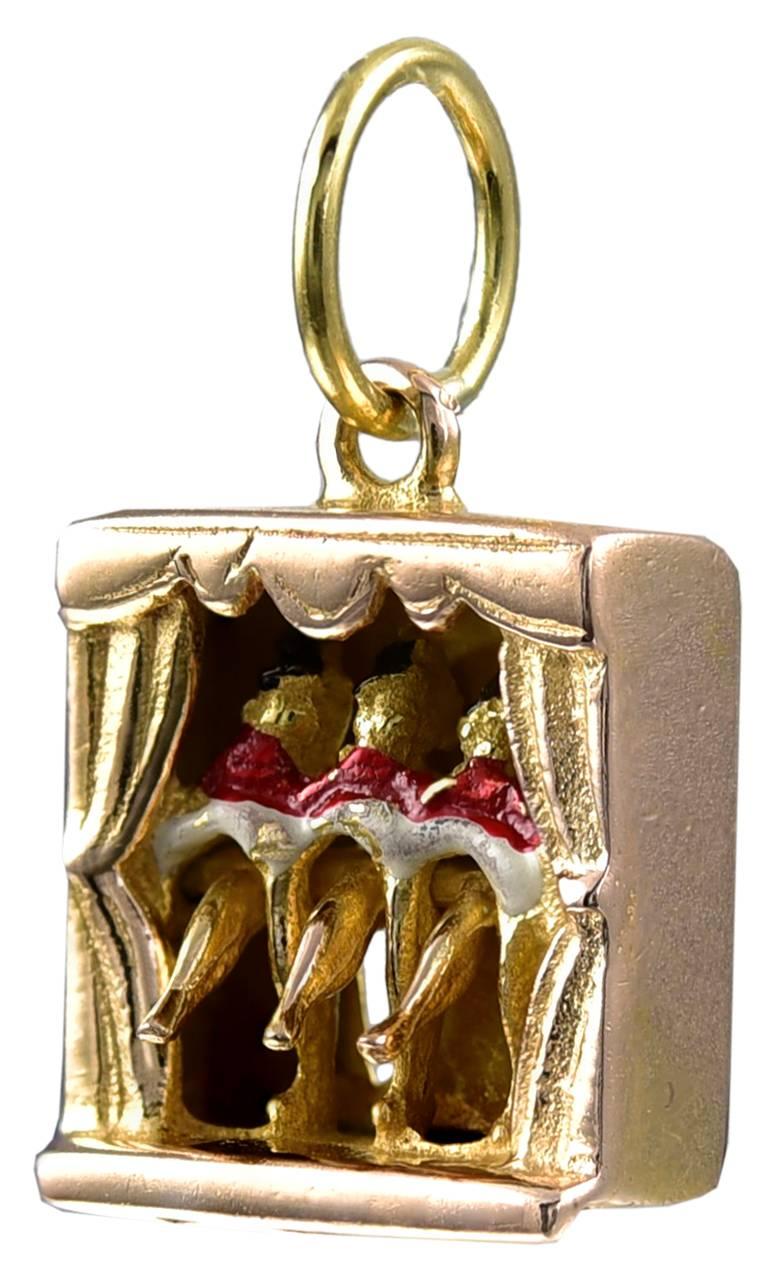 Never before seen figural "Can Can" charm.  Three dancers, with top hats, 
wearing red and white costumes.  14K yellow gold.  When you move the lever in back, the three front legs kick upward.  1/2" x 1/2."  A hilarious addition