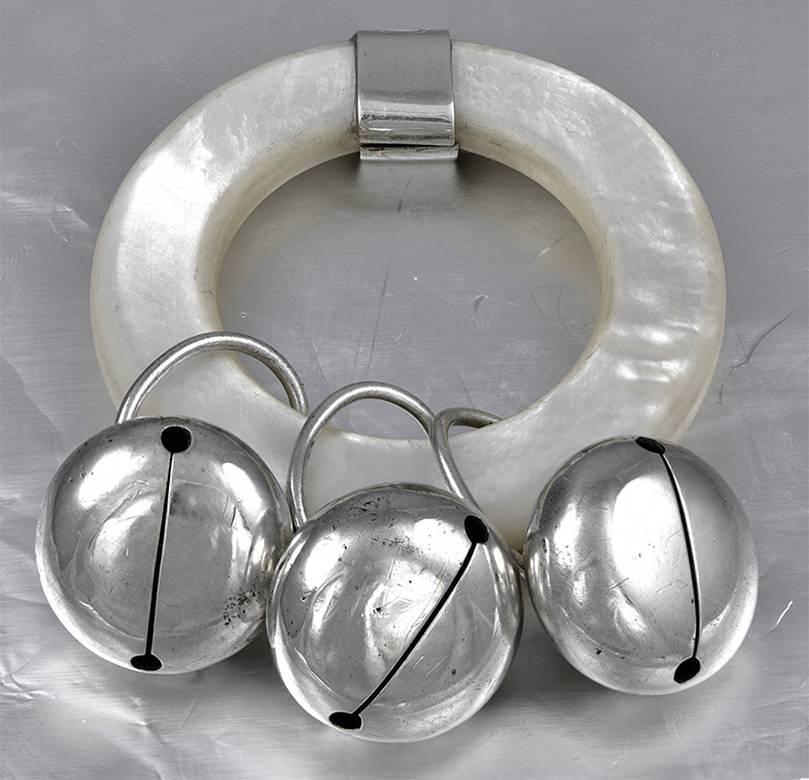 Antique baby rattle.  Made and signed by TIFFANY & CO.  Three sterling silver bells are suspended from a mother-of-pearl ring.  2" in diameter.  A special gift for a special baby.

Alice Kwartler has sold the finest antique gold and
