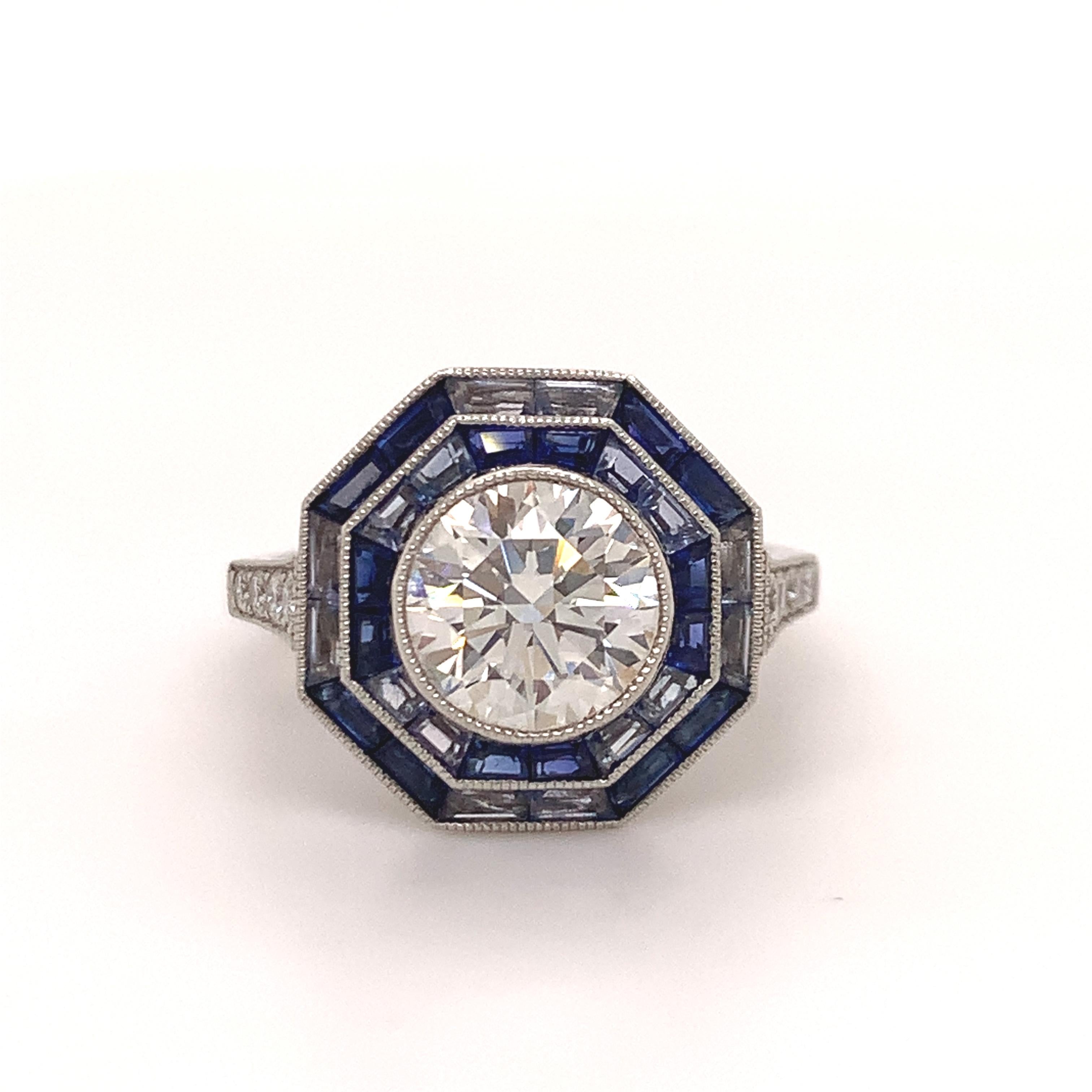 Gorgeous ring made and signed by Tiffany & Co. Platinum, diamond and sapphire octagonal ring with milgrain beading.  Center Round brilliant cut diamond weighing 1.78cts, G color, VVS2 clarity, surrounded by a double row, set with 30 calibre cut