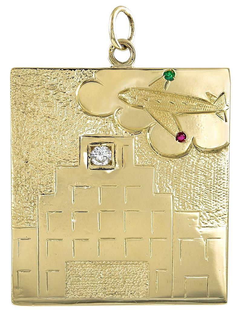 A totally unique piece of jewelry:  a large DEAR pendant, showing a tall apartment building, with a diamond indicating the penthouse.  Flying above is an airplane, set with a ruby, an emerald and an amethyst.  To celebrate a life well-lived, for the