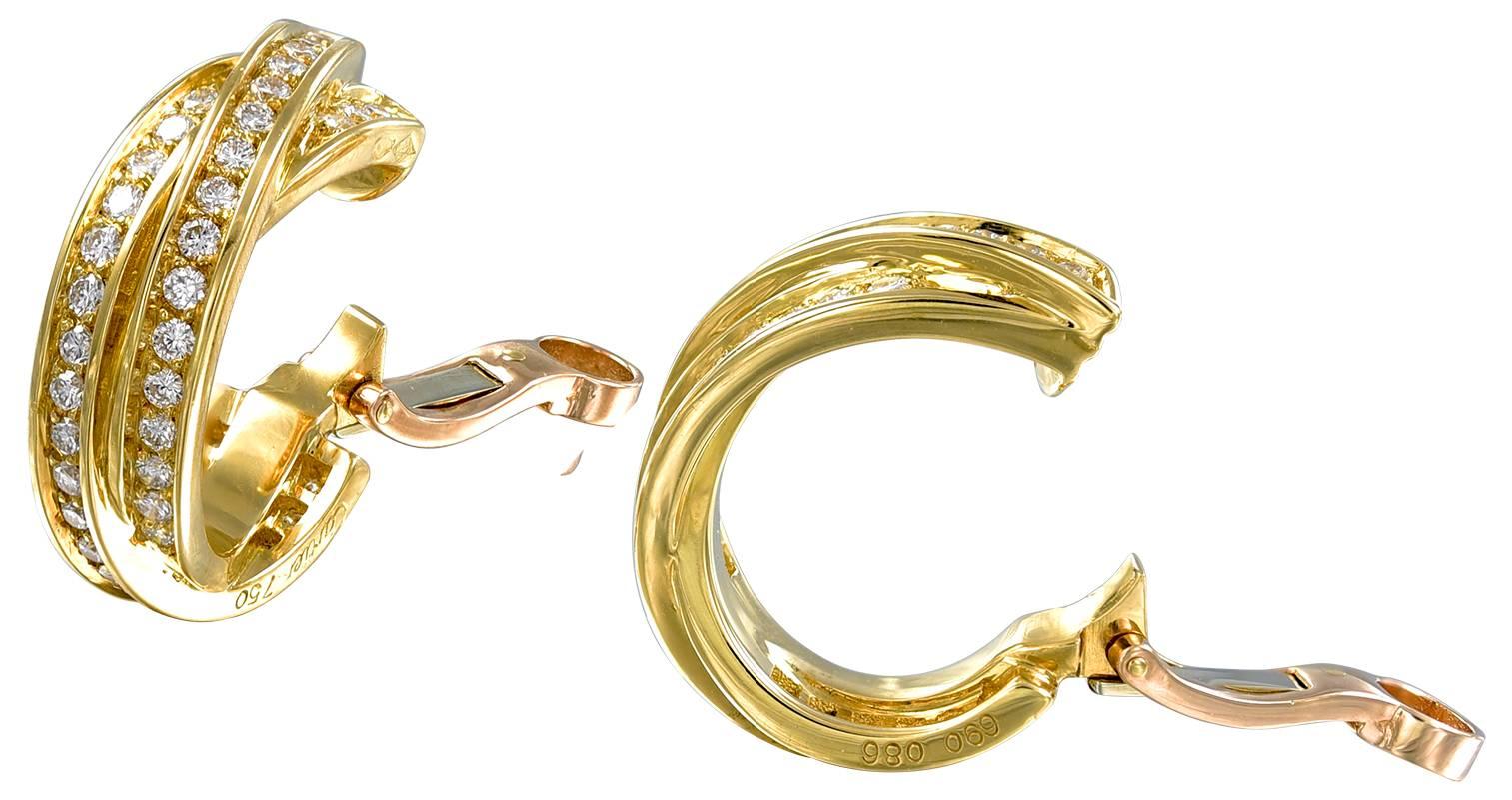 Classic elegant "Trinity" earrings.  Made, signed and numbered by CARTIER France.  18K yellow gold, encrusted with approximately 2.75 cts. of brilliant white diamonds.  3/4" in diameter.  The perfect day to night earring.

Alice