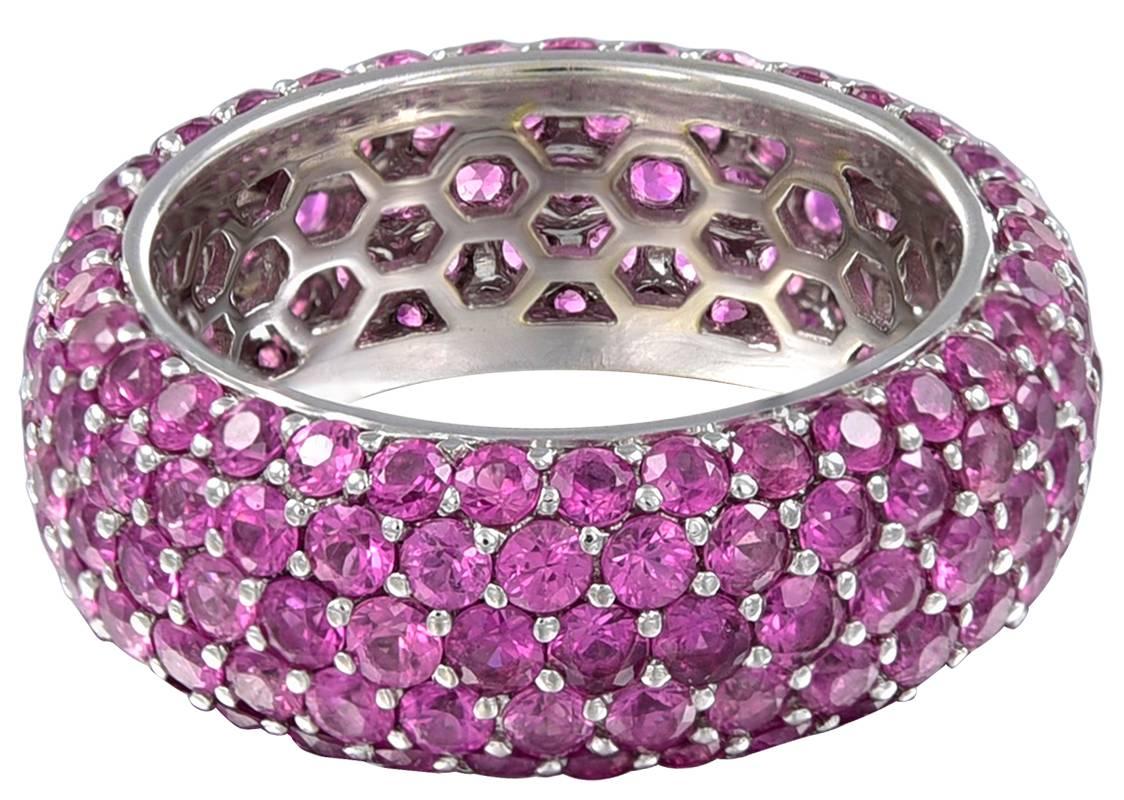Softly curved eternity ring. Fully set with 6.00 carats of bright faceted pink sapphires.  18K white gold.  Size  5 1/2; 1/4" wide.  Beautiful color; a striking look.

Alice Kwartler has sold the finest antique gold and diamond jewelry and